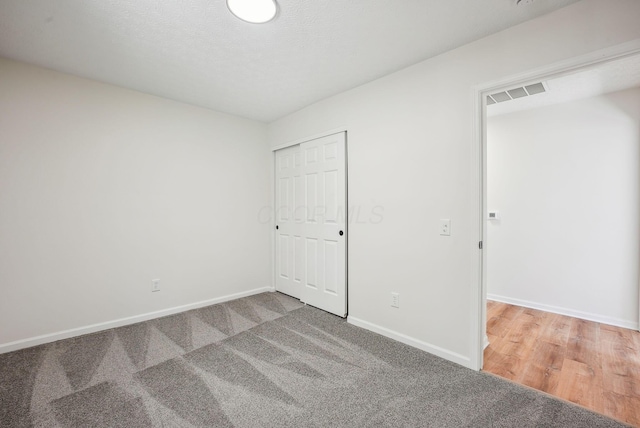 spare room with visible vents, baseboards, and carpet floors