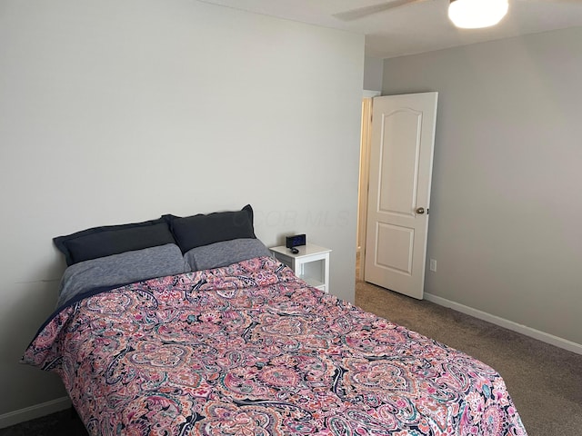 carpeted bedroom featuring baseboards and ceiling fan