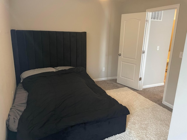 bedroom with baseboards, visible vents, and carpet floors