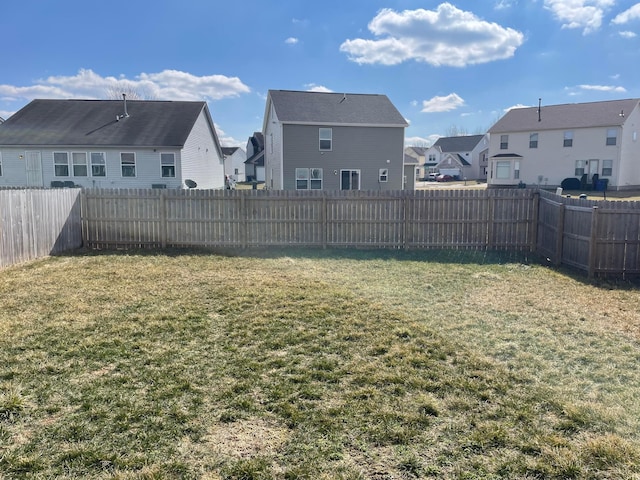 view of yard featuring a residential view and a fenced backyard