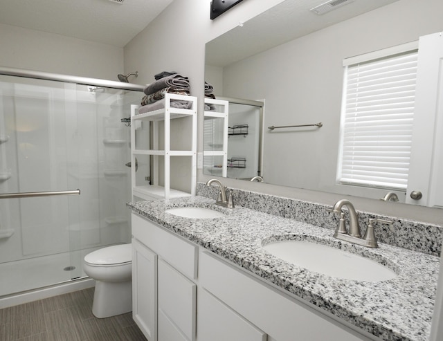 4835 Amber Crossing Dr, Columbus, OH 43232 - bathroom with a shower stall, visible vents, toilet, and a sink