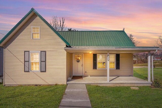 view of front of house with a front yard and metal roof