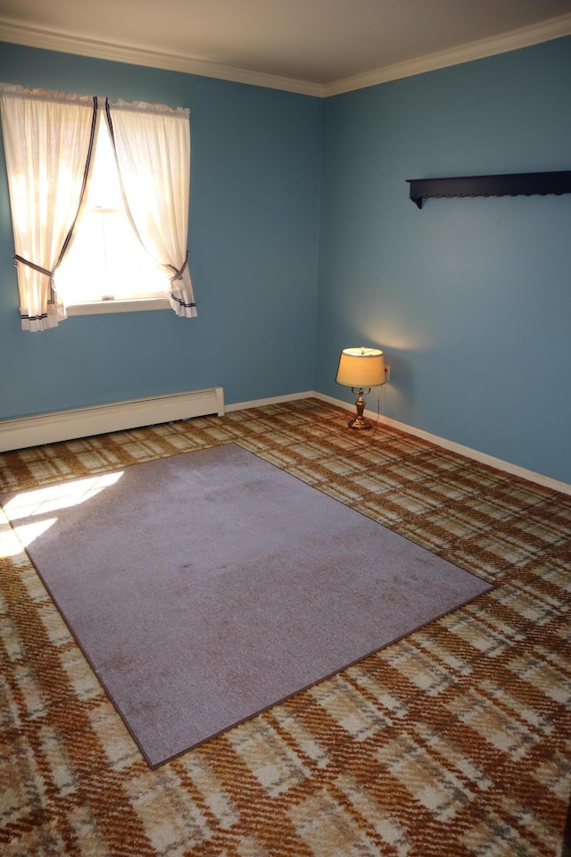 spare room featuring carpet flooring, baseboards, baseboard heating, and ornamental molding