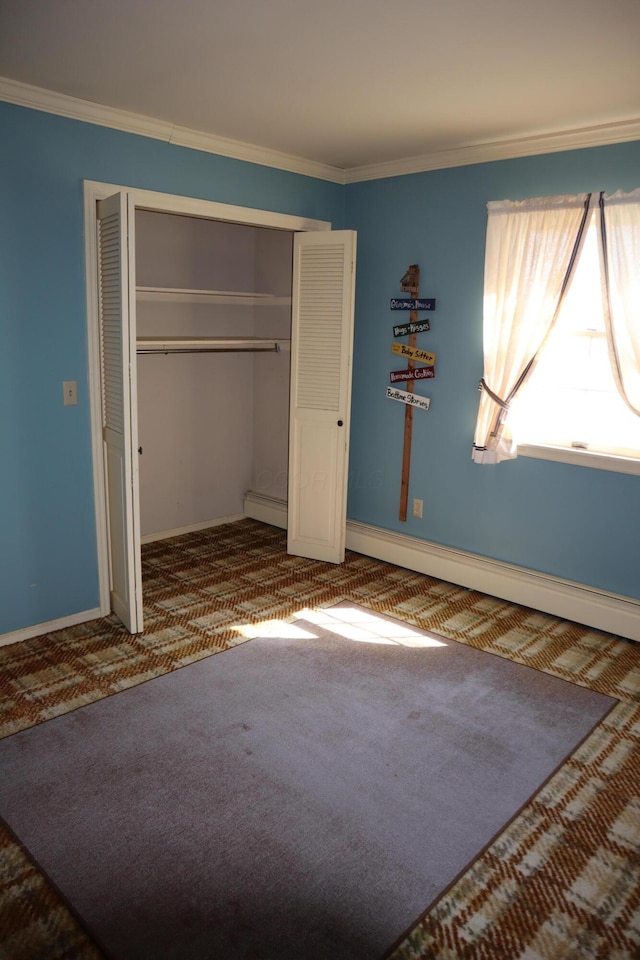 unfurnished bedroom featuring crown molding, baseboards, carpet, a closet, and a baseboard radiator