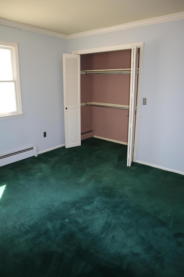 unfurnished bedroom with a closet, carpet floors, crown molding, baseboards, and baseboard heating