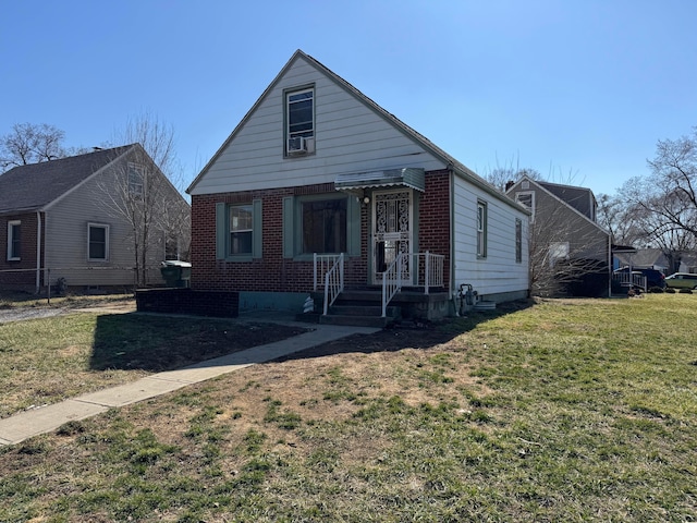 view of front facade featuring a front lawn and brick siding