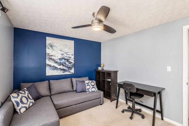 office area featuring baseboards, a textured ceiling, a ceiling fan, and carpet floors