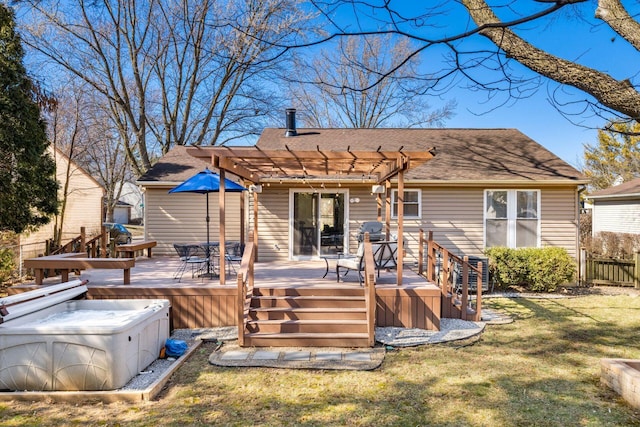 back of property with a hot tub, fence, a wooden deck, a lawn, and a pergola