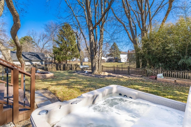 view of yard with fence private yard and a hot tub