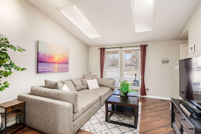 living area with lofted ceiling with skylight, baseboards, dark wood-type flooring, and visible vents