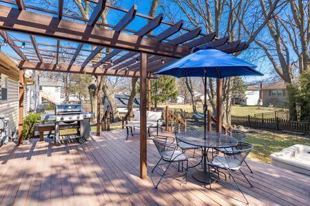 deck featuring outdoor dining area, area for grilling, a pergola, and fence