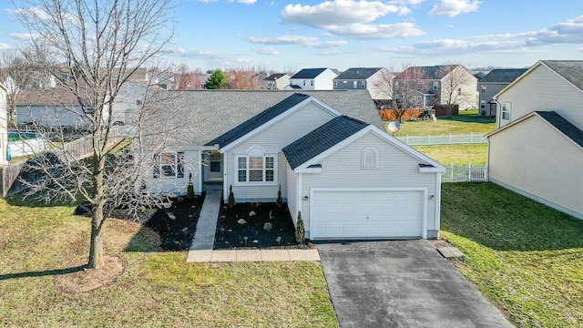 view of front of property with aphalt driveway, fence, an attached garage, a shingled roof, and a front yard