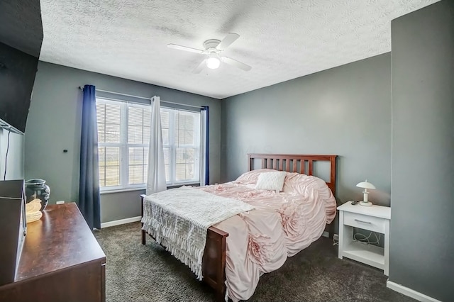 carpeted bedroom featuring a textured ceiling, a ceiling fan, and baseboards