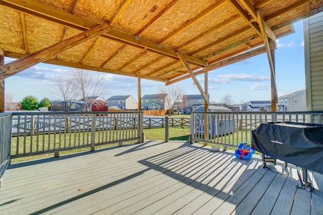 deck featuring grilling area, a residential view, and fence