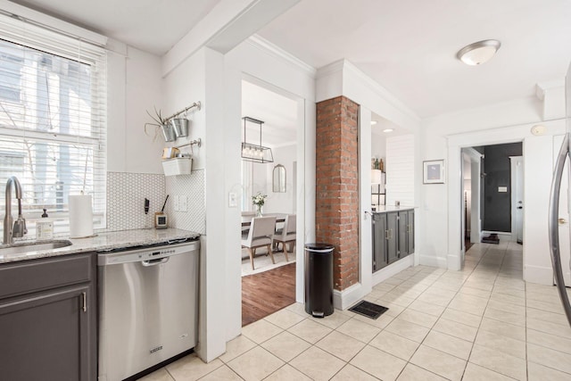 kitchen featuring visible vents, a sink, light tile patterned floors, decorative backsplash, and dishwasher