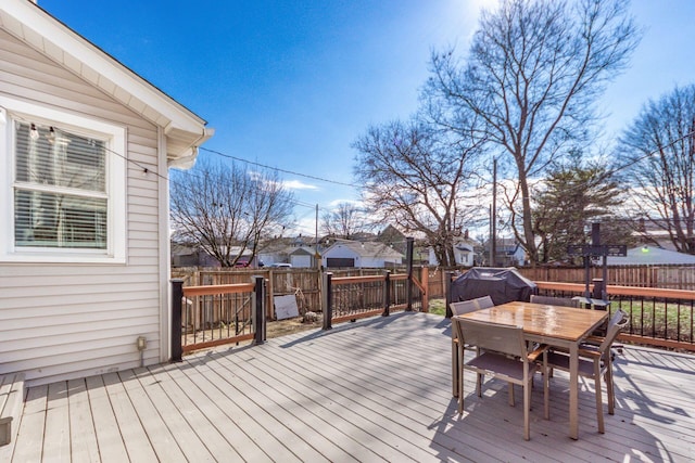 wooden deck featuring outdoor dining space and a fenced backyard