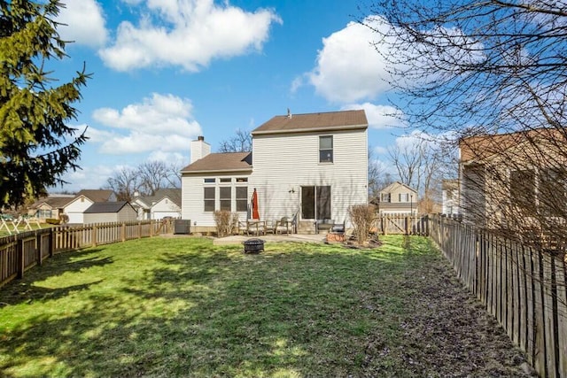 back of house featuring central air condition unit, a lawn, a chimney, a fenced backyard, and a patio area