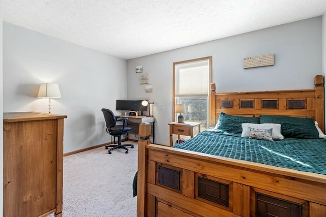 bedroom with baseboards, light colored carpet, and a textured ceiling