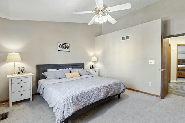 bedroom featuring visible vents, light carpet, baseboards, and ceiling fan