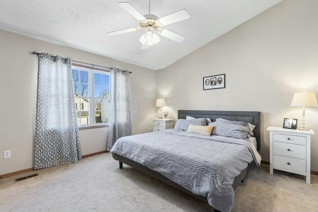 bedroom with visible vents, baseboards, carpet, and vaulted ceiling