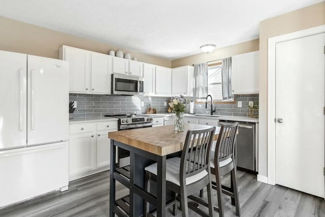 kitchen featuring a sink, light countertops, white cabinetry, and stainless steel appliances