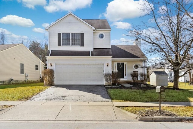 traditional home with a garage, driveway, a chimney, and a front lawn