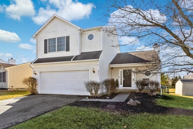 traditional-style house featuring a garage and driveway