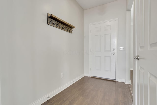 interior space featuring dark wood finished floors and baseboards