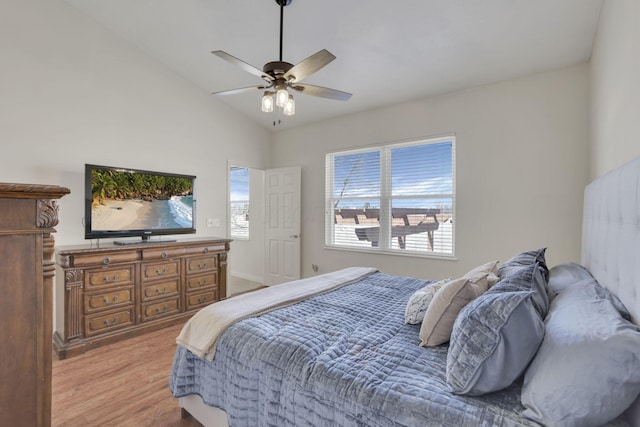 bedroom with ceiling fan, light wood-type flooring, and lofted ceiling