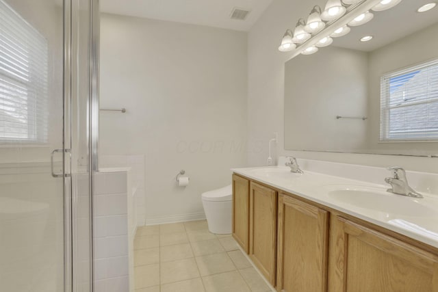 bathroom featuring visible vents, a sink, a shower stall, tile patterned floors, and toilet