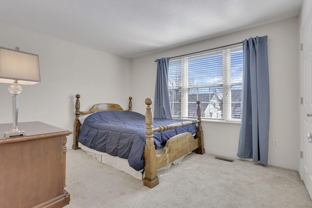 carpeted bedroom featuring visible vents and baseboards