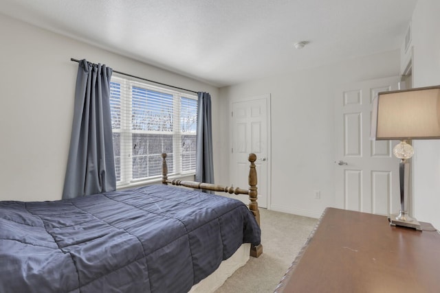 bedroom featuring baseboards and light colored carpet