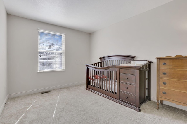 carpeted bedroom featuring visible vents and baseboards