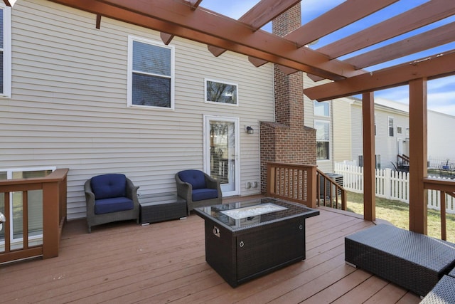 wooden terrace featuring a pergola, an outdoor fire pit, and fence