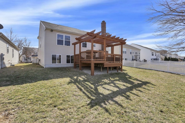 rear view of house featuring a pergola, a chimney, a deck, fence private yard, and a lawn