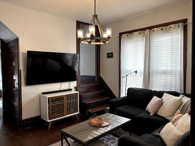 living room with dark wood finished floors, stairway, baseboards, and a chandelier