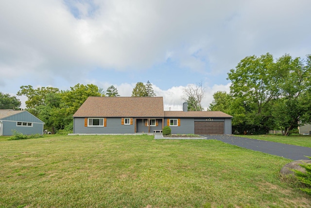 single story home featuring aphalt driveway, an attached garage, and a front yard