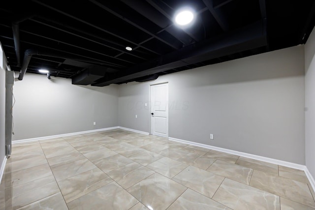 finished basement featuring light tile patterned floors and baseboards