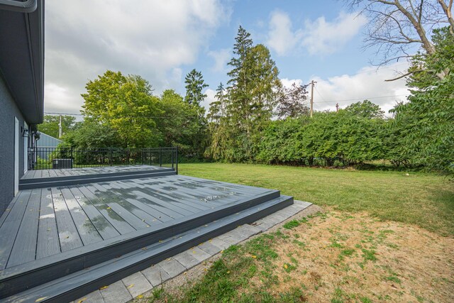 wooden terrace with central AC unit and a yard