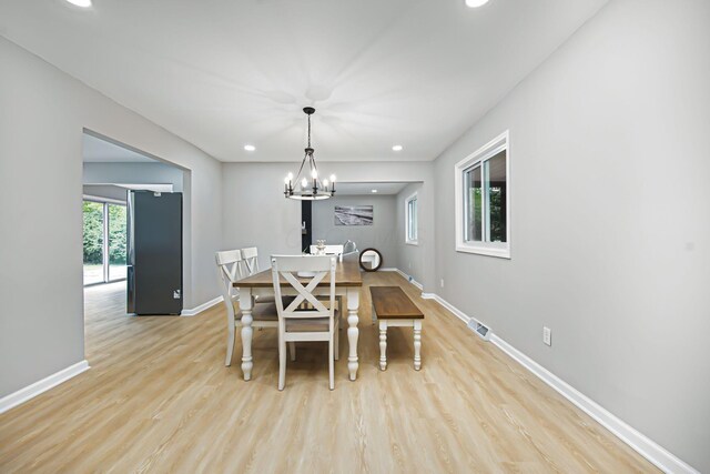 dining area with visible vents, recessed lighting, light wood finished floors, baseboards, and a chandelier