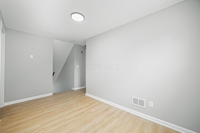 unfurnished room featuring visible vents, baseboards, and light wood-style flooring