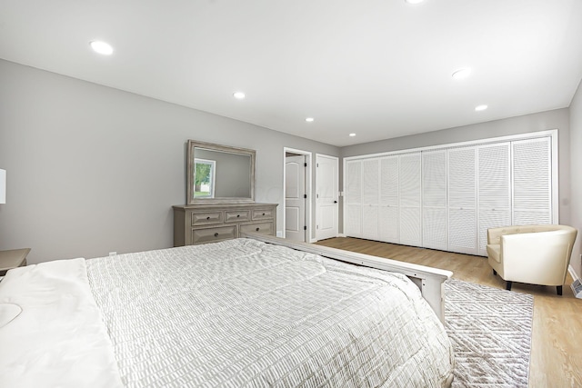 bedroom with recessed lighting and wood finished floors