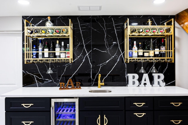 bar featuring beverage cooler, wet bar, tasteful backsplash, and a sink