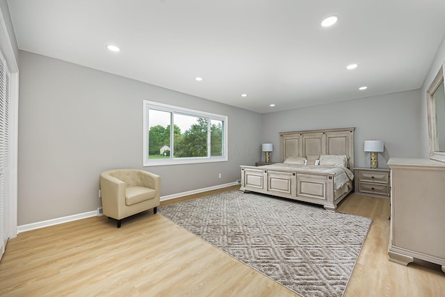 bedroom with recessed lighting, baseboards, and light wood-type flooring