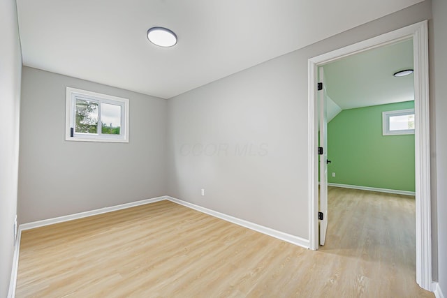 unfurnished room featuring baseboards and wood finished floors