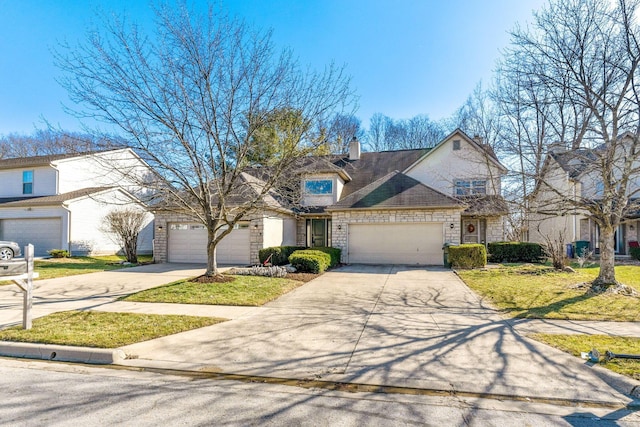 view of front facade featuring a front yard, an attached garage, a chimney, concrete driveway, and stone siding