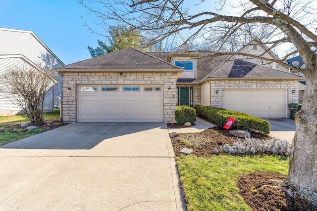 view of front of home featuring stone siding, concrete driveway, and an attached garage