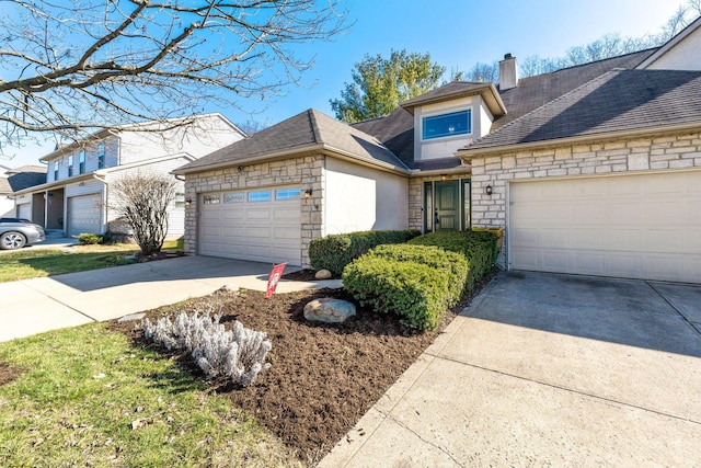 view of front of home featuring stone siding, a garage, driveway, and a chimney