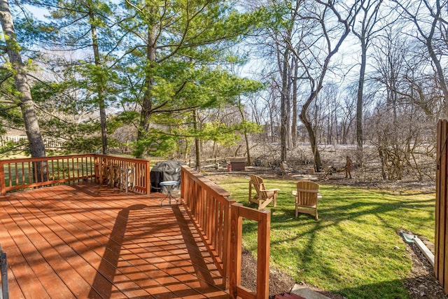 wooden terrace with a lawn and grilling area