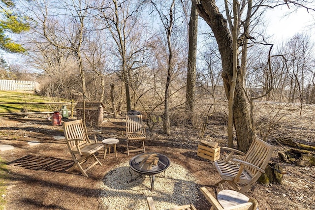 view of patio / terrace with a fire pit and fence